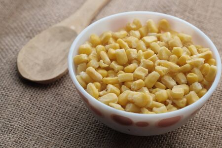 close up of sweet corn in a bowl on tableの写真素材