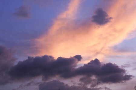 dramatic sunset sky with clouds and sun, close up.の写真素材