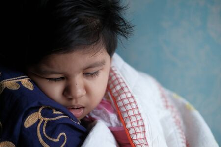 Close up of baby child sleeping on mother shoulderの写真素材