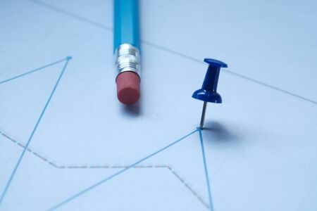 close up of push pin on stock chart with pencils on paper.の写真素材