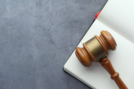 Close up of gavel , book and handcuff on table