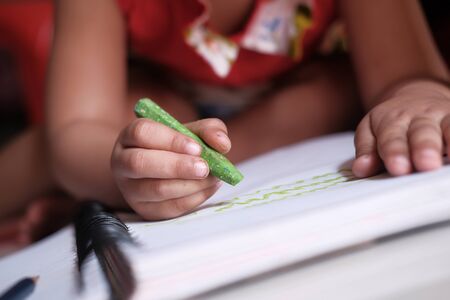 child girl drawing with color pencil on paperの写真素材