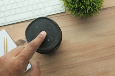 smart speaker and notepad on wooden tableの写真素材