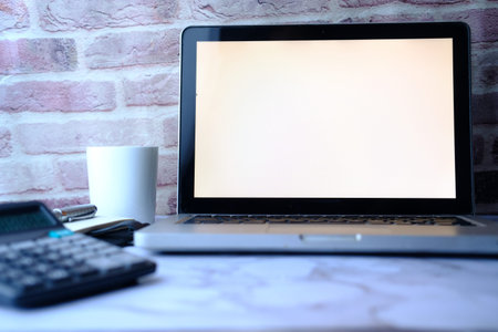 laptop with white screen on office table