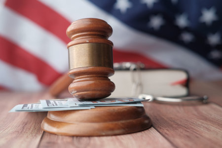 Close up of gavel , book and handcuff on table