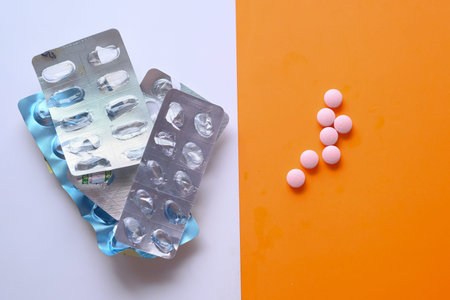 empty blister pack and pills on color background