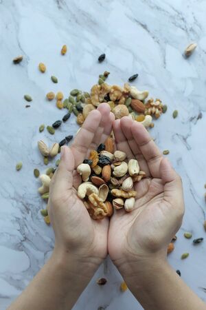top view of mixed nut on women handの写真素材