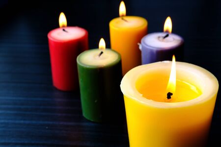 Close up of colorful burning candle at nightの写真素材