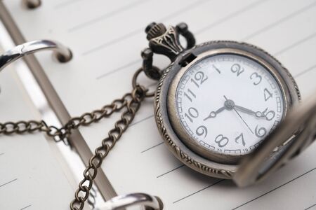 old pocket watch on a dairy, close upの写真素材