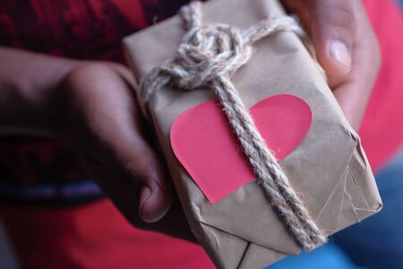 Close up of man hand holding gift boxの写真素材