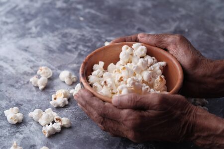 Close up of women eating popcorn on table .の写真素材