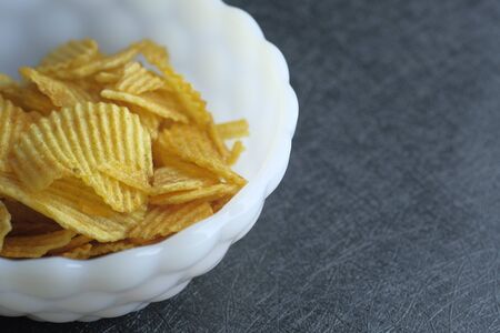 Close up of potato chips in a bowl.の写真素材