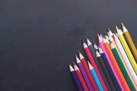 close up of colorful pencils on blackboard.の写真素材
