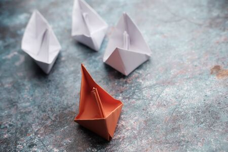 leadership concept with paper boat on tableの写真素材