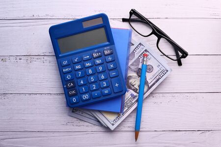 top view of cash , calculator and notepad on tableの写真素材