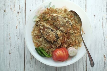 mutton biriyani served in a bowl on white background.の写真素材