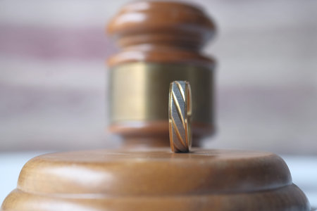Divorce concept with gavel and wedding rings.の写真素材