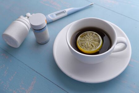 Close up of lemon tea and pills on table.の写真素材