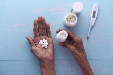 top view of pills on palm of senior women handの写真素材