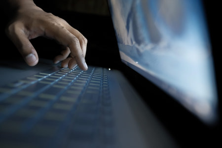 hacker stealing data from laptop, close up