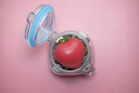 top view of Charity money jar on pink backgroundの写真素材