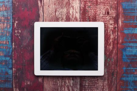 top view of digital tablet with blank screen on tableの写真素材