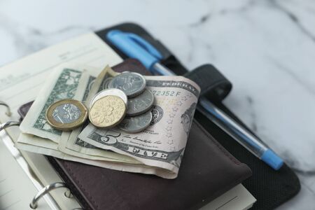 top view of cash ,wallet and pen on table .の写真素材