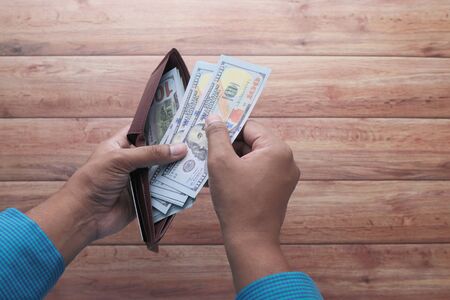 close up of man hand counting cash.の写真素材