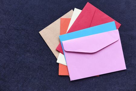 close up of colorful envelope on black background .の写真素材