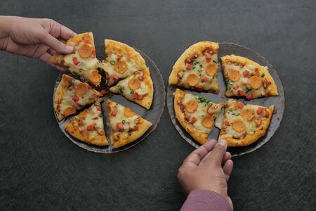 slice of pizza and salad leaves in a plate on the table.の写真素材