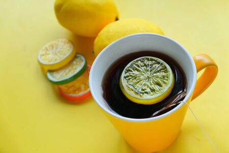 Close up of lemon tea and slice of lemon on yellow background .の写真素材