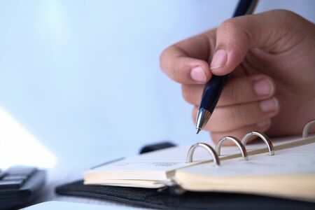close up of women hand writing on notepadの写真素材