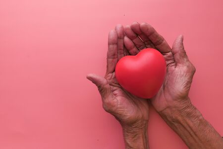 top view of heart shape symbol on senior women handの写真素材