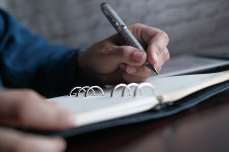 close up of women hand writing on notepadの写真素材