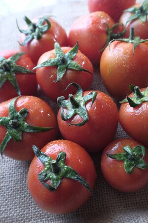 top view of fresh and ripe tomato on tableの写真素材
