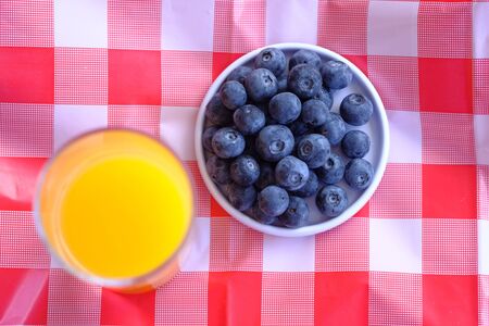 berry fruits, juice and banana on table for breakfastの写真素材