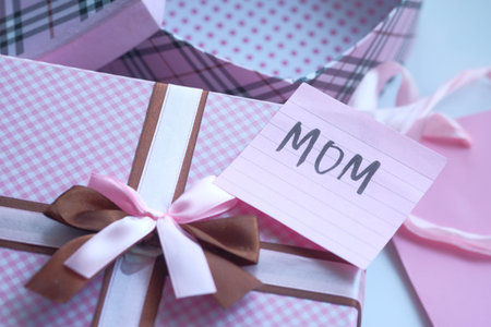 Happy Mothers Day gift on pink background .