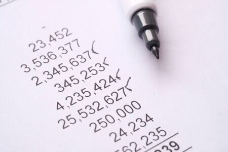 Close up of accounting data and pen on paperの写真素材
