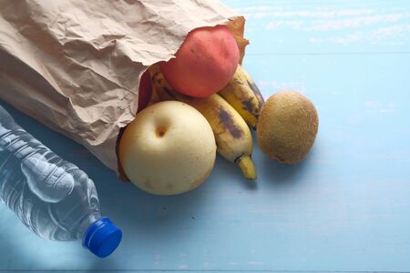 Fresh organic fruits and vegetables in reusable textile shopping bags.の写真素材
