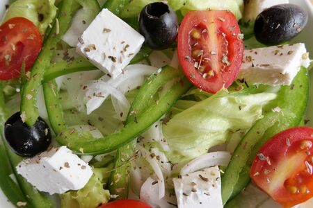 Fresh greek salad - feta cheese, tomato, lettuce, black olives and onionの写真素材