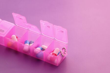 Close up of pink color pills in a pill boxの写真素材
