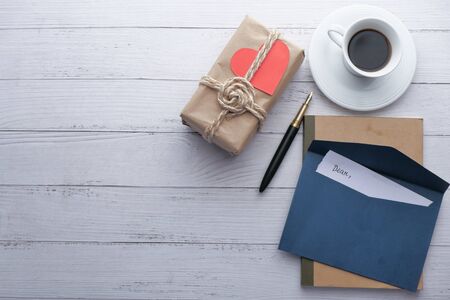 top view of gift, tea and envelope on table .の写真素材