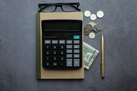 top view of cash , calculator and notepad on tableの写真素材