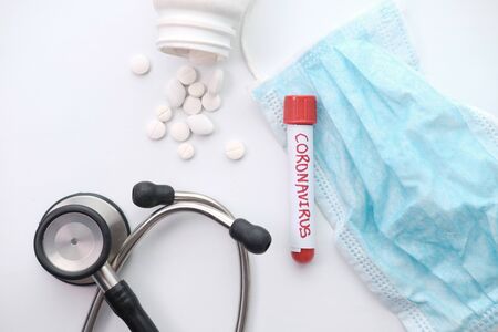 Coronavirus blood test concept. Top view desk in laboratory with pills, test tubesの写真素材