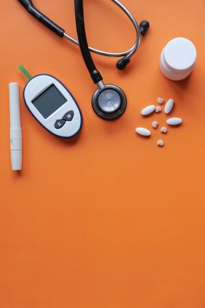 Glucometer, blood sugar measurement for diabetes, pills and stethoscope.の写真素材