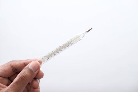 man hand holding thermometer isolated on whiteの写真素材