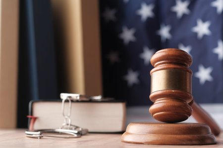 Close up of gavel, book and handcuff on table