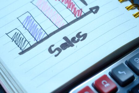 Close up of growth chart on notepad on orange backgroundの写真素材