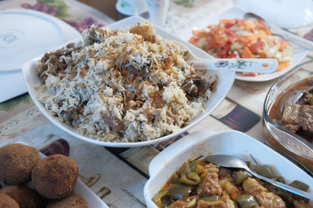 Close up of indian rice and curry on plate on table.