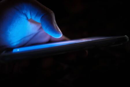 close up of person hand use smart phone at nightの写真素材